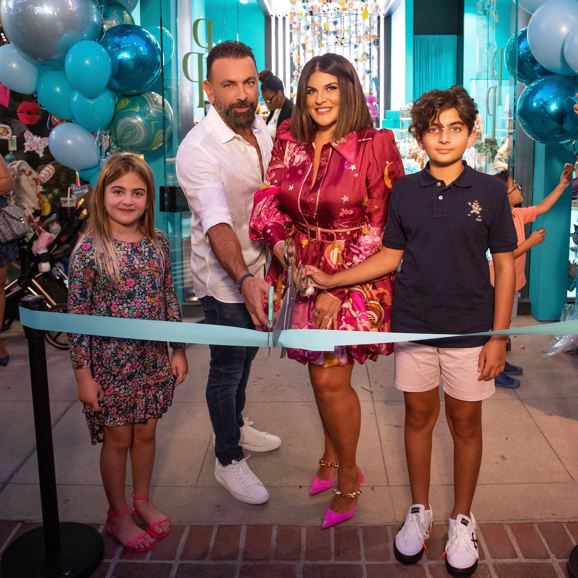 Fiona and her family cutting the ribbon to open first Posh Peanut store
